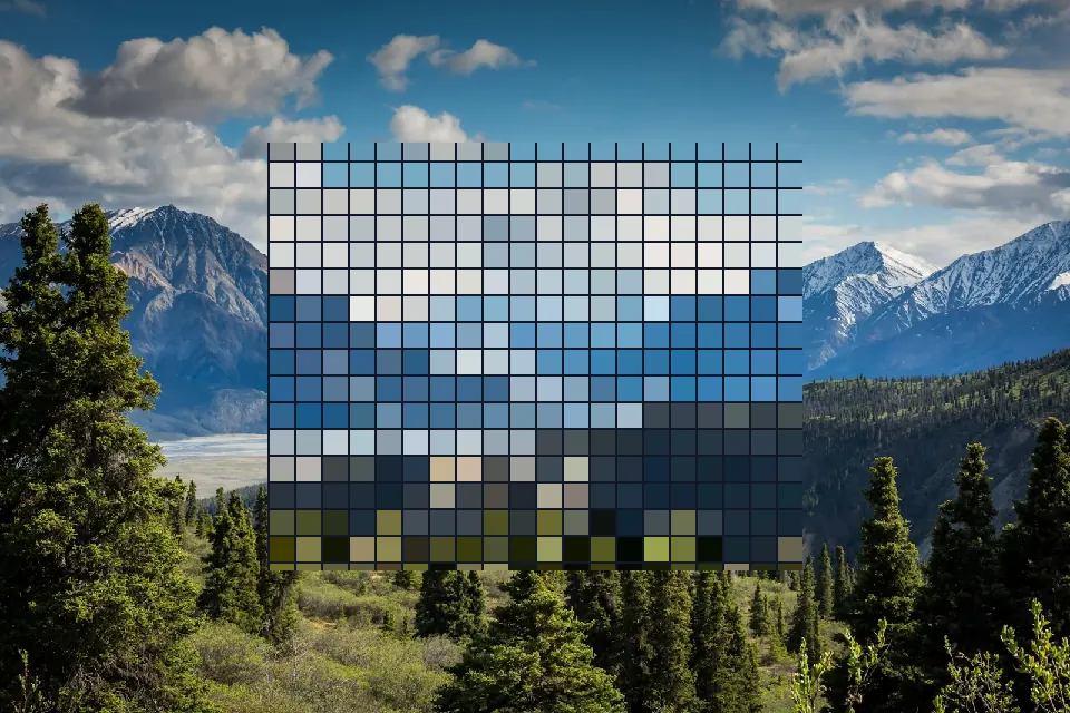 Pixelated rectangle with grid lines inside a mountain photograph